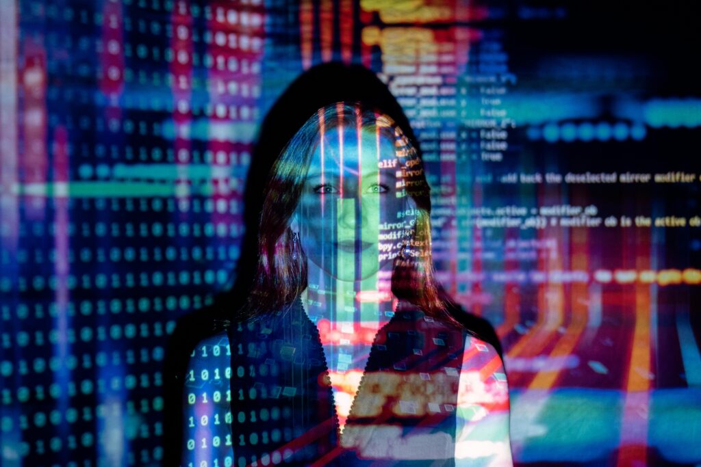 Sesame AI 리뷰 | 가장 현실적인 음성 AI 비서| 5가지 차별점 | Ambrosia A woman with digital code projections on her face, representing technology and future concepts.